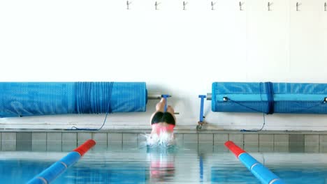 fit woman diving into pool