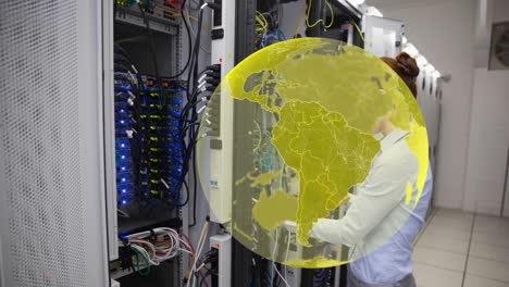 Animation-of-globe-over-caucasian-female-worker-inspecting-server-room