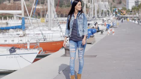 pretty woman strolling on a waterfront promenade