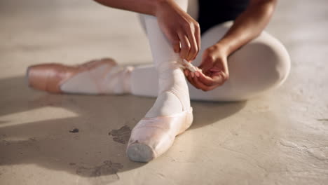 ballet, shoes and hand of dancer tie ribbon