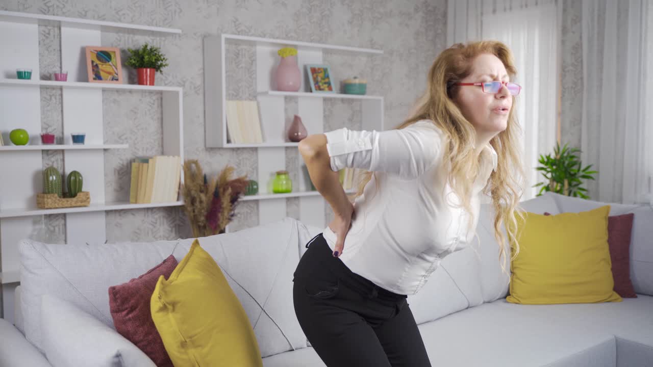 The old woman has lower back pain.