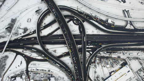 cars driving on road interchange at winter. top view snowy highway intersection