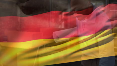 Animación-De-La-Bandera-De-Alemania-Sobre-Un-Ingeniero-Birracial-Mirando-El-Plano-Del-Plano.