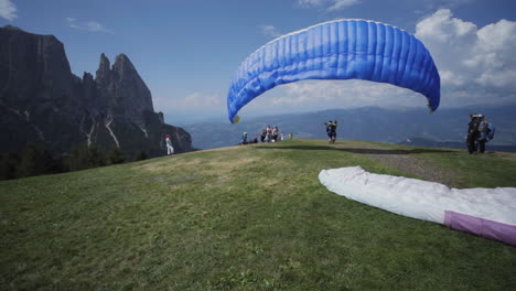 starting paraglider on seisser alm, italy
