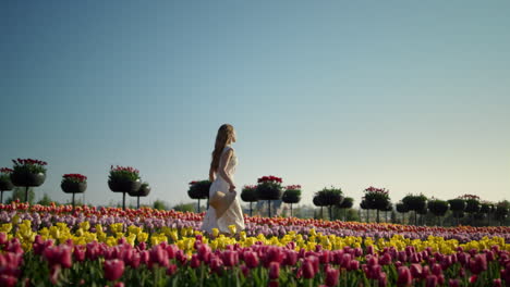 young woman relaxing in summer flower garden. girl feeling free outdoors