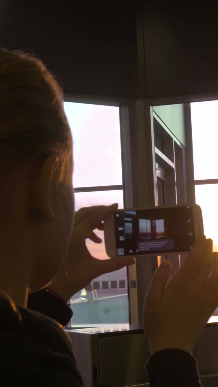Person taking a photo at an airport window