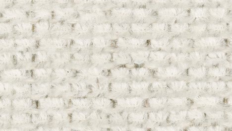 macro shot slowly pans, revealing plush white carpet and subtle grey motif