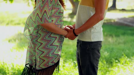 mid-section of couple holding hands 4k