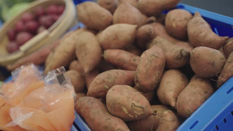 close up shot of raw sweet potatoes at a grocery store in minnesota, usa.