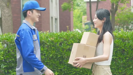 delivery man uniform smiles during express, courier holding a small package parcel delivering goods to customer's home with van truck, door-to-door services