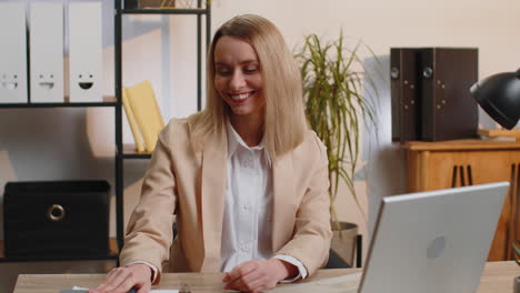 Portrait-of-happy-smiling-blonde-young-business-woman-at-home-office-look-away-turn-head-at-camera