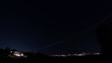 jet trails cross the sky in a busy air traffic corridor in central utah - light trails time lapse