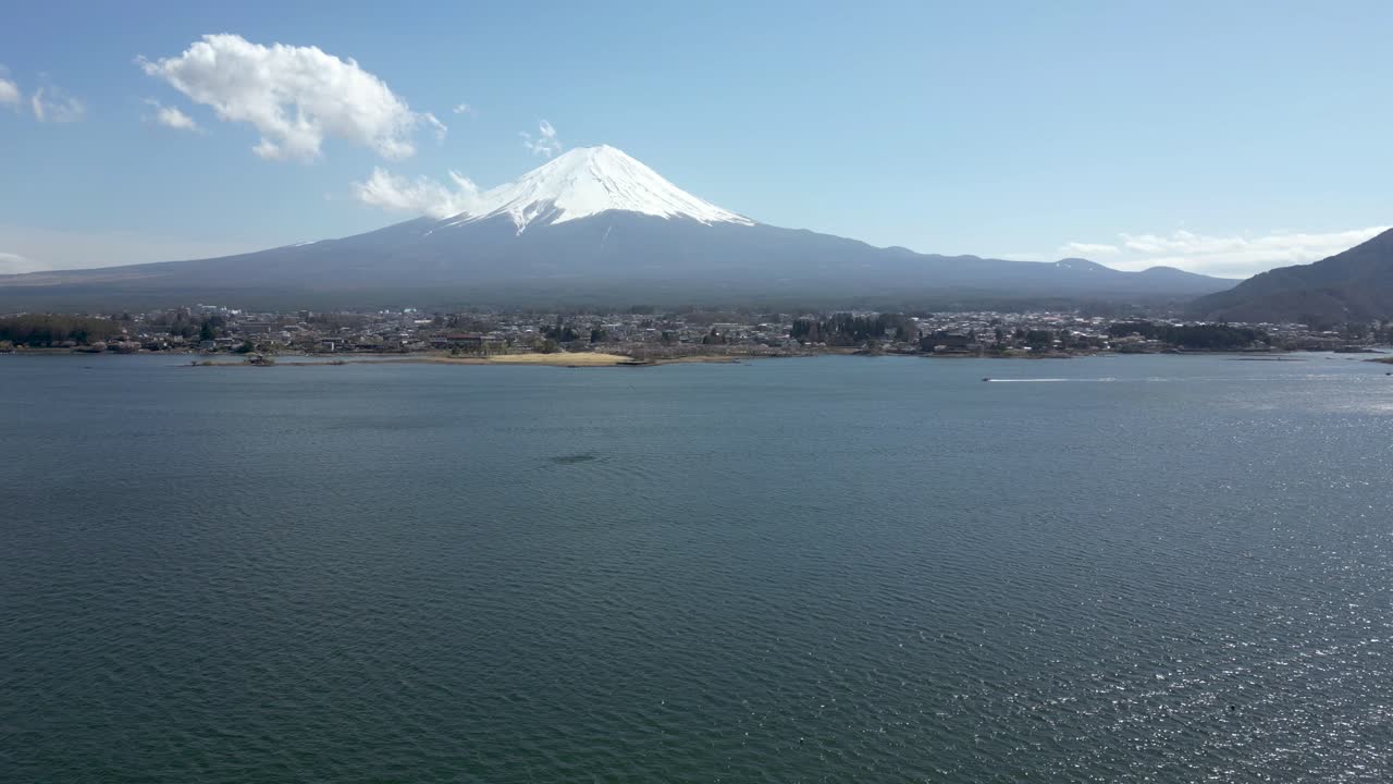 Speedboat passing in front of Mt. Fuji on lake Kawaguchiko in Japan