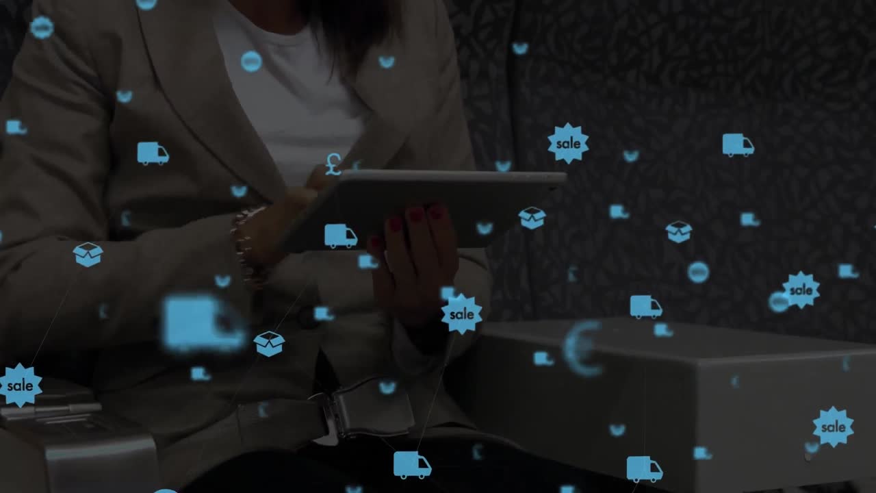 Digital composite video of digital icons against woman using a digital tablet in background