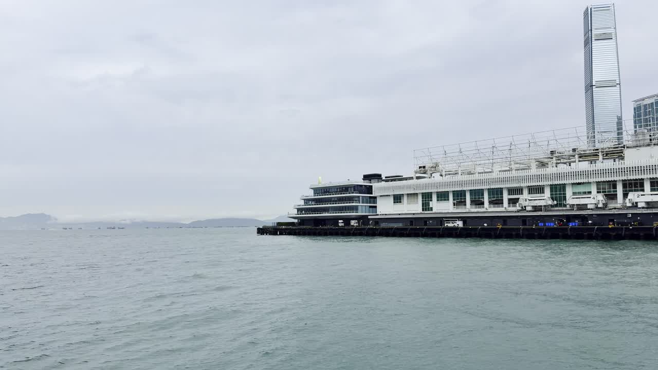 Footage captured from a ferry in Hong Kong, showcasing the city skyline, bustling harbor, moving vessels, and waterfront activity, highlighting the dynamic energy and scenic beauty of Victoria Harbour