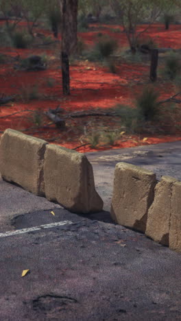 road barrier in a red dirt landscape