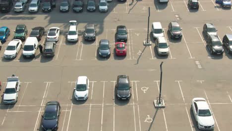 aerial top view of the shopping mall parking lot with cars and empty spots