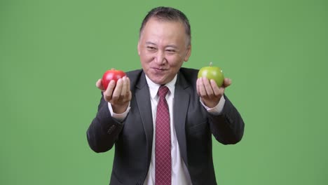 mature japanese businessman with apples