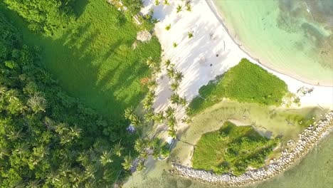 overhead drone shot panning above beachfront of miami resort, a perfect getaway located in central greece, facing the ionian sea