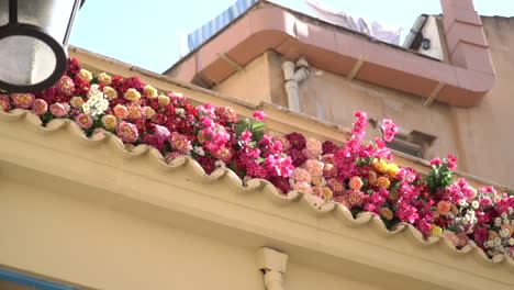 vintage building with pink and red flowers on