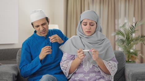 worried muslim couple checking pregnancy test