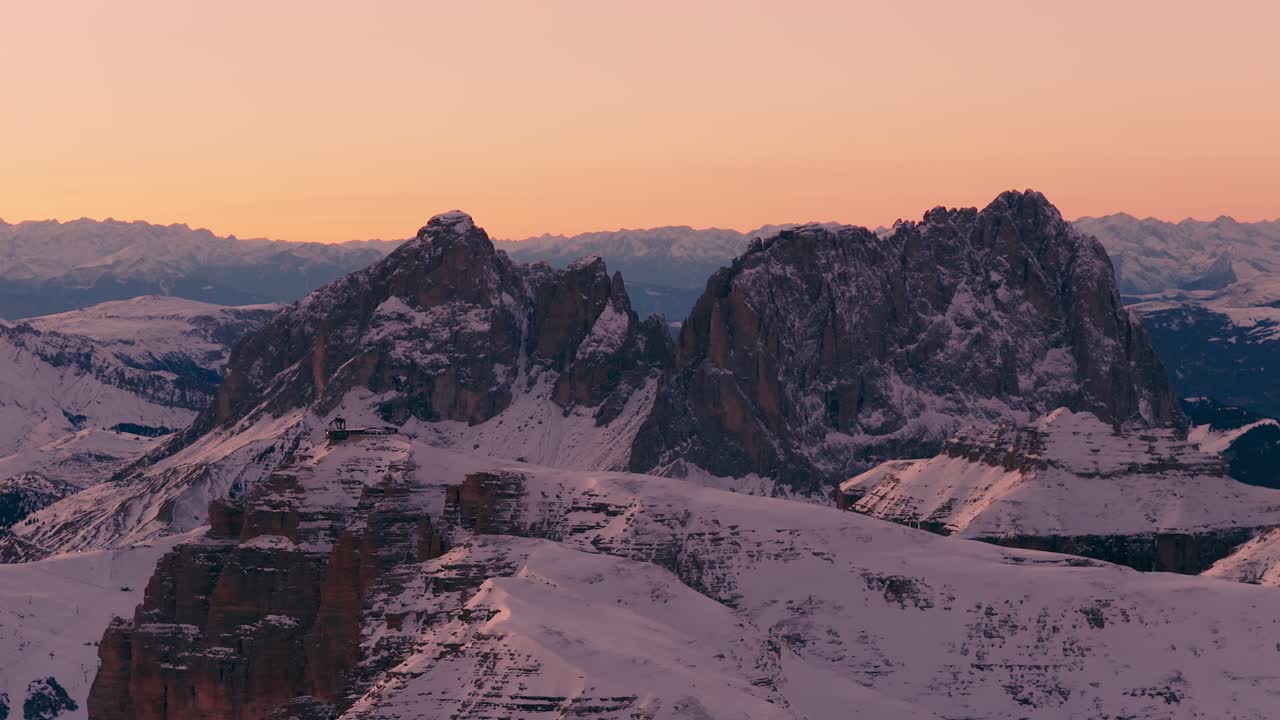 Captivating sunset view over the snow-capped peaks of Passo Pordoi in Italy