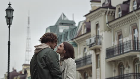 love couple kissing on urban street. happy man and woman enjoying date outdoor.