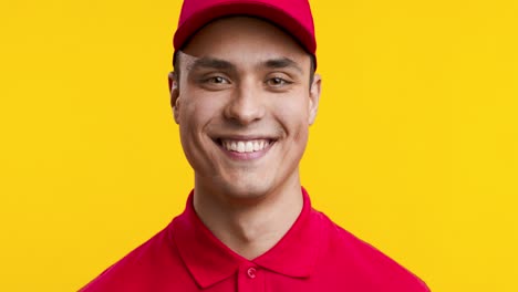 smiling delivery driver in red uniform