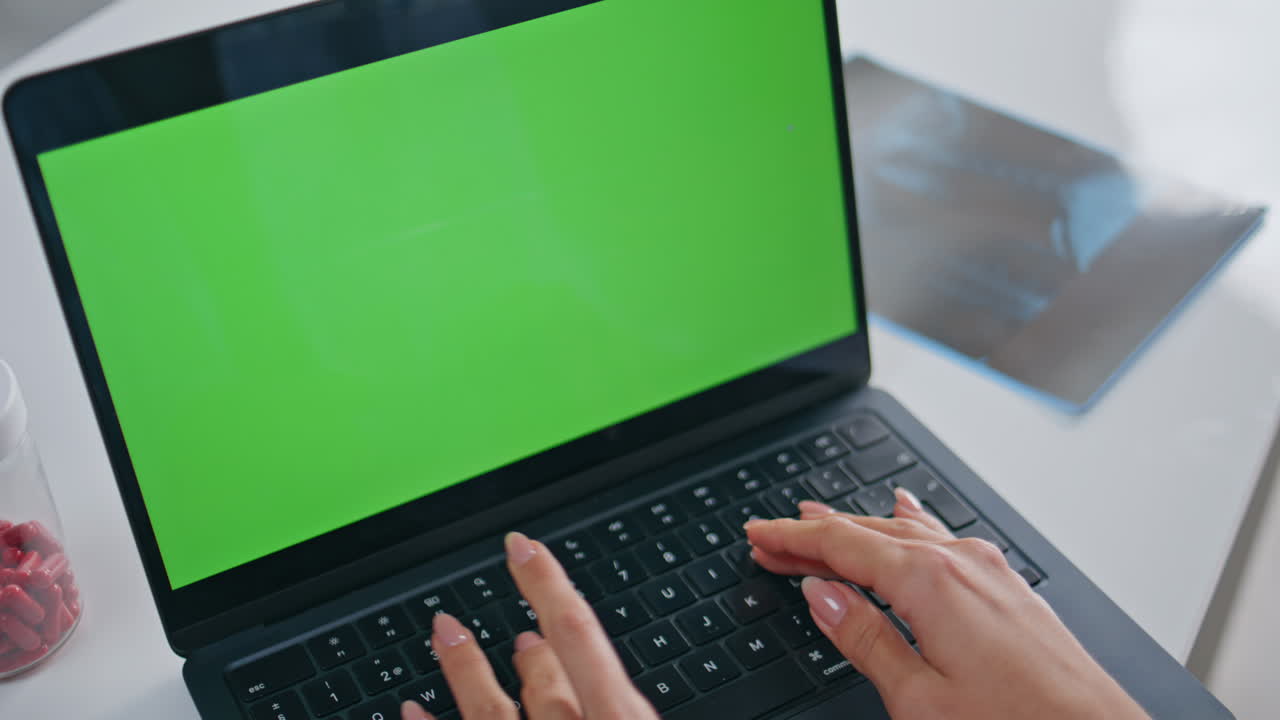 Medical practitioner typing mockup laptop in healthcare facility office closeup