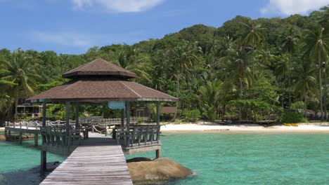 a gazebo on a dock in the ocean on a tropical beach crop