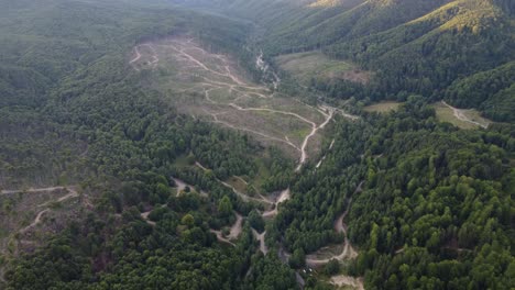 Aerial:-Hill-valley-forest-in-Romania,-Central-Europe---Deforestation-concept
