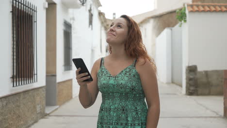 woman holding a smartphone on a european street