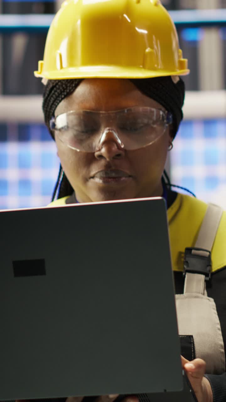 Vertical video Smart factory engineer using laptop to implement automated workflows