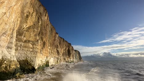 tall large white chalk cliffs on coast of sussex with english channel