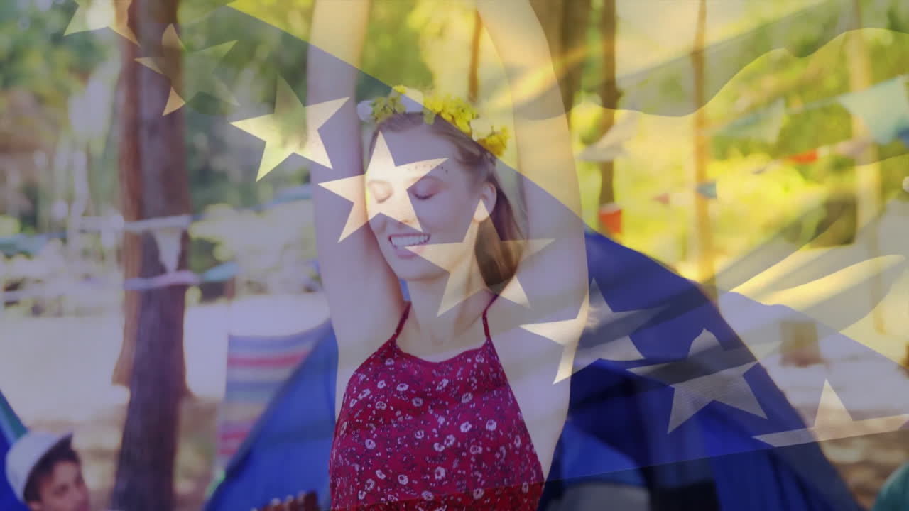 Stars and stripes animation over woman dancing at outdoor festival