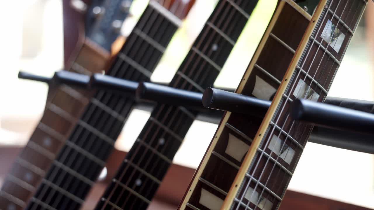 Close up view of acoustic and electric guitar necks.