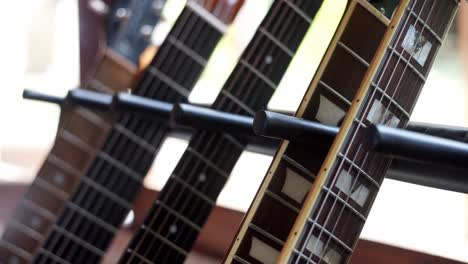 close up view of acoustic and electric guitar necks.