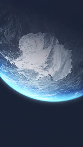 vertical video moving towards planet earth from space moving towards whole of antarctica. southern most continent covered in ice.