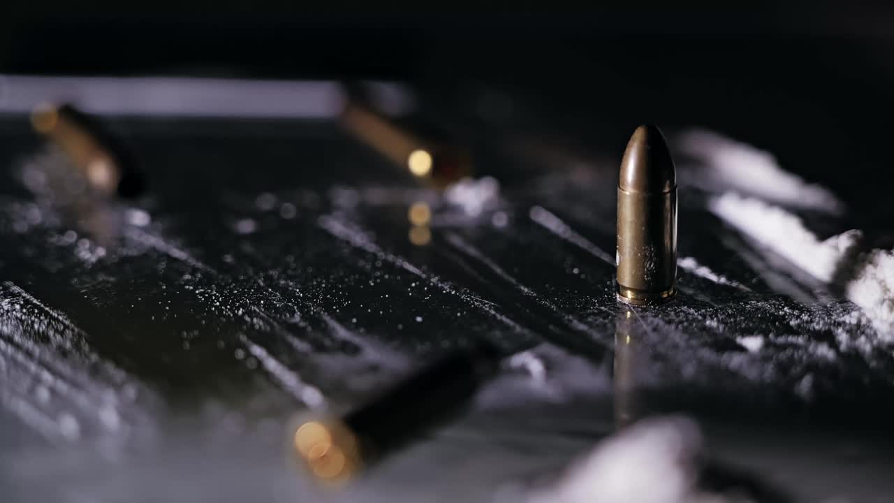 Slow motion of fifty euro bill falling near bullets and cocaine residue on glass