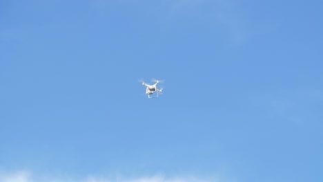 drone in flight against a clear blue sky