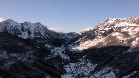 AERIAL---Snowy-winter-in-the-mountains-around-Kolasin,-Montenegro,-truck-right