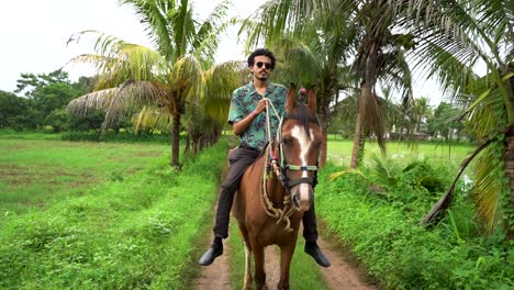 Young-handsome-man-with-brown-horse