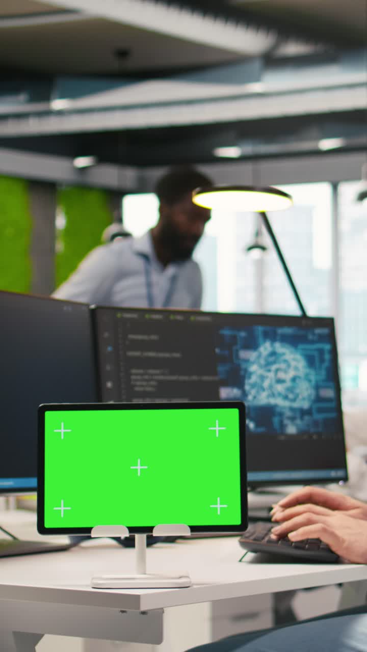 Vertical video Technician developing applications using chroma key tablet, integrating AI