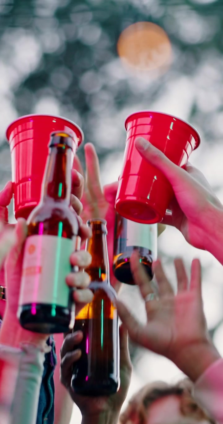 Group of Friends Raising Drinks for a Toast at an Outdoor Party