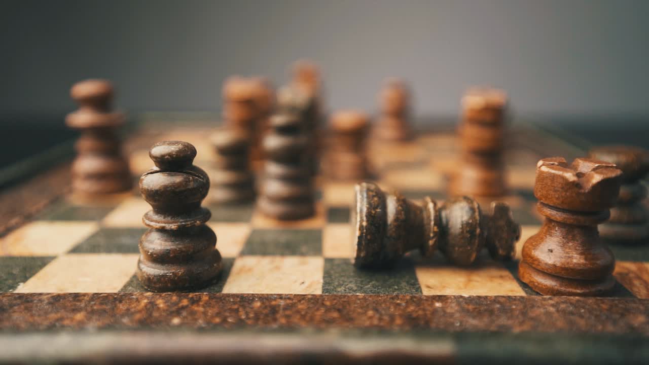 Chess black king falling in slow motion at checkmate