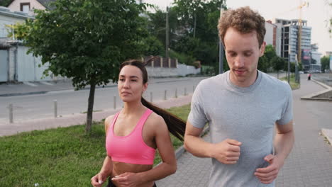 Happy-Couple-Running-Together-In-The-City-While-Talking-To-Each-Other