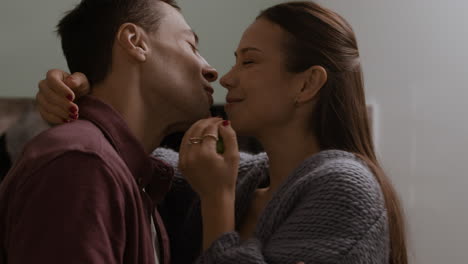 couple sharing apples in the kitchen