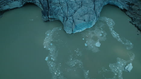 icebergs falling in the water while a glacier is melting due to climate change