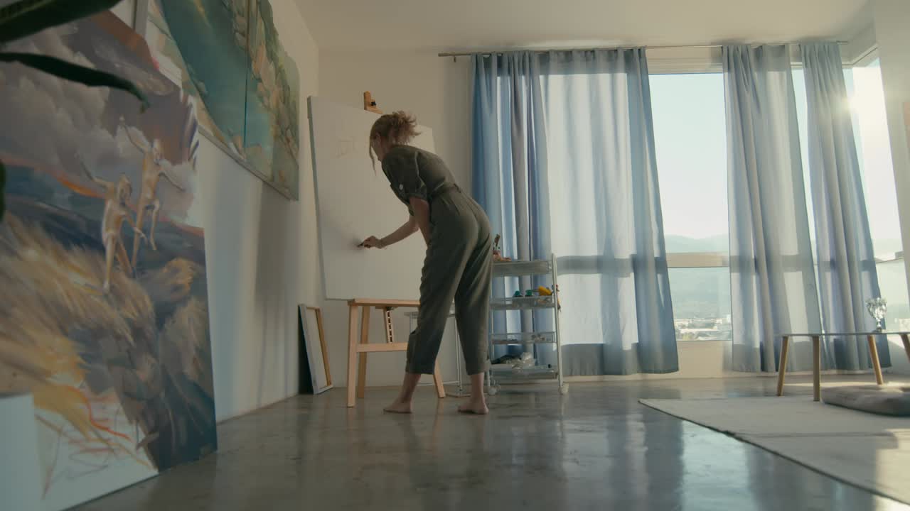 Woman Artist Painting in a Cozy Home Studio with City Views