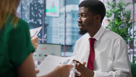 Professional-team-of-recruiters-evaluating-job-candidate-resume-during-interview